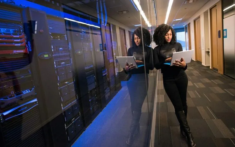 Technicians walking a data center server corridor